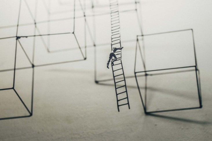feat-img_safety-ii-a-facinating-development-in-safety-management-and-solution-focus-an-article-by-mark-mckergow_toy-miniture-man-climbing-ladder